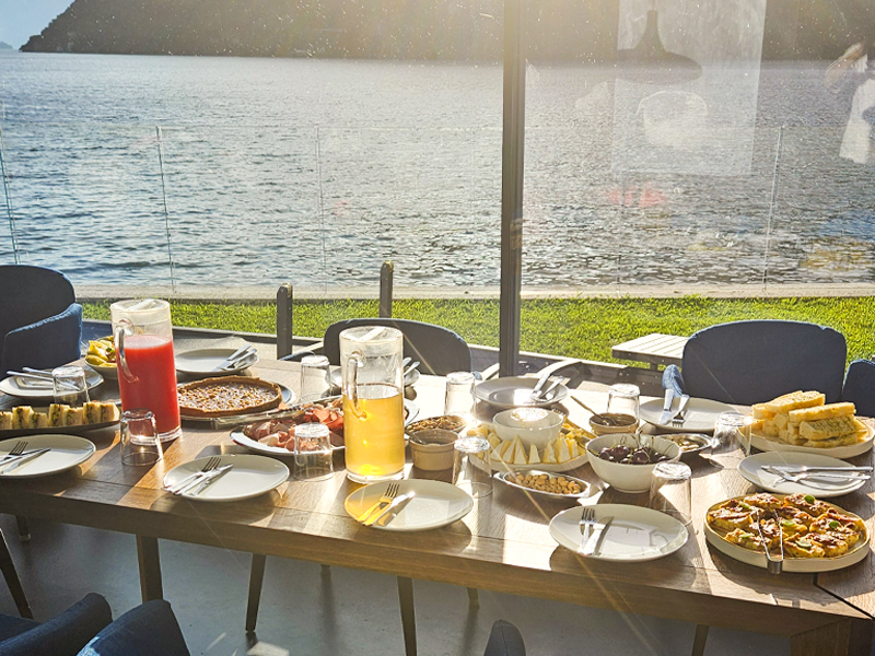 Breakfast table set buffet-style with a lake view, prepared by Private Chef Lake Como - Lecco