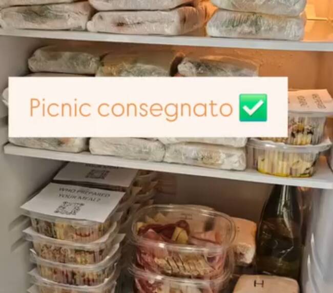 Refrigerator stocked with sandwiches and cold pasta boxes, ready for a group boat day, Varenna, Lake Como